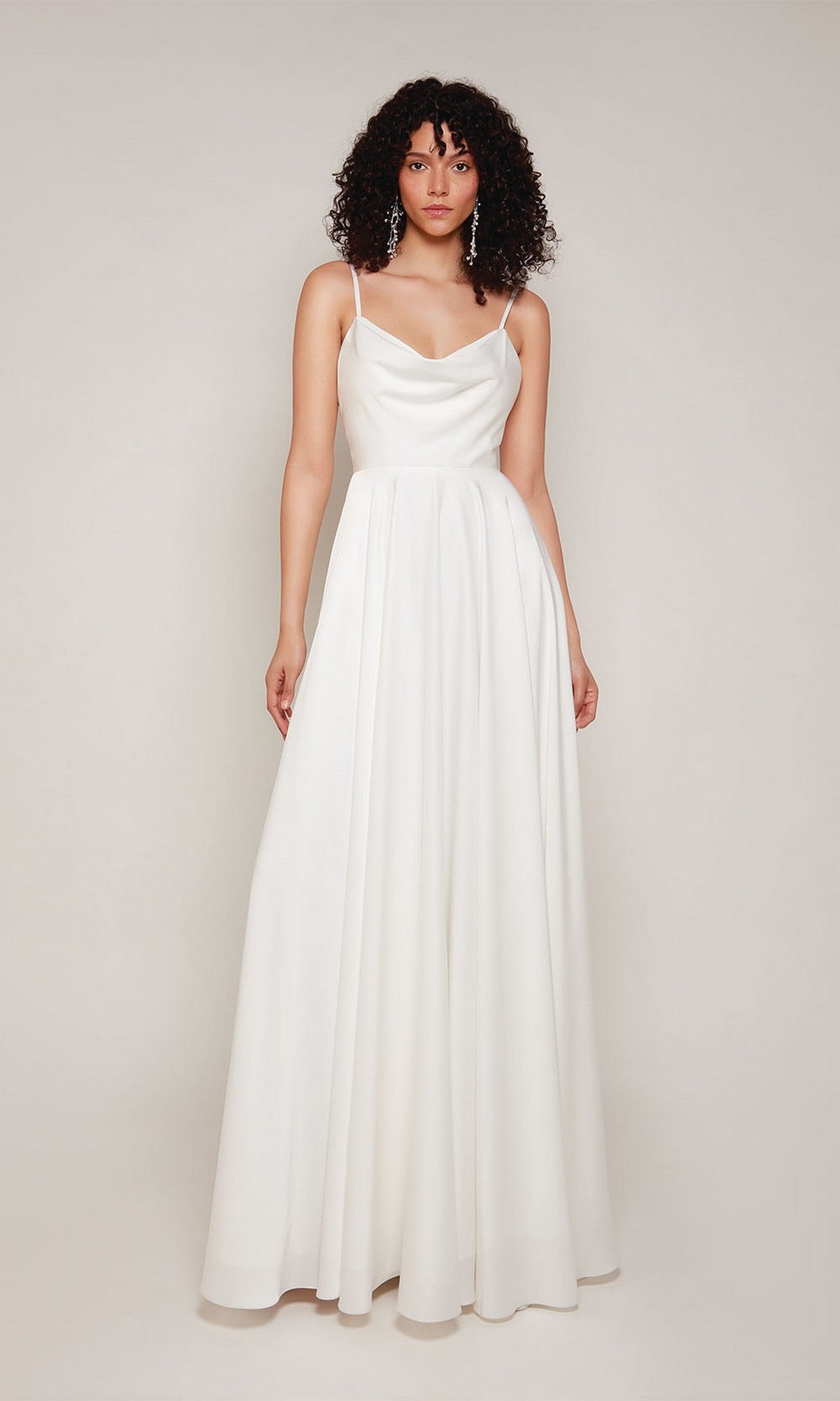 A woman models the Alyce 7100, a sleeveless, floor-length white satin formal dress with thin straps, standing against a plain light background.